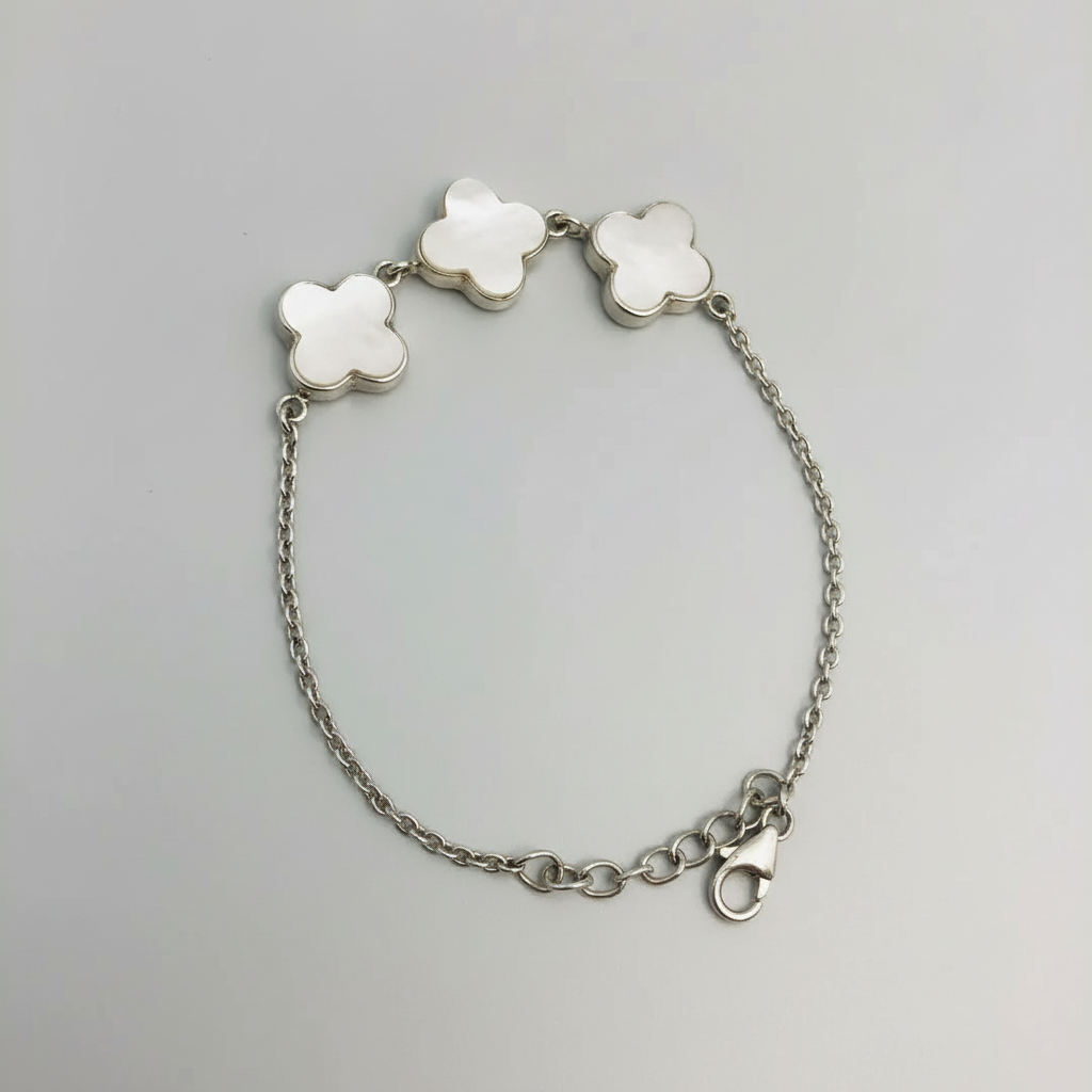 Bracelet with floral-shaped clasps on a light blue fabric background