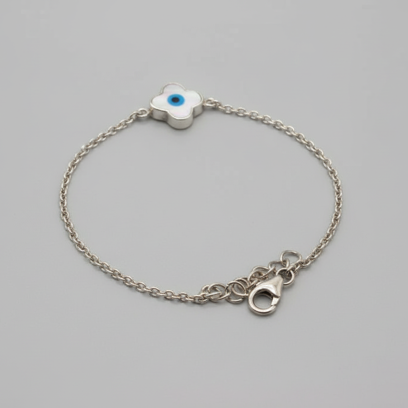 Silver bracelet with a clasp on a light blue fabric background