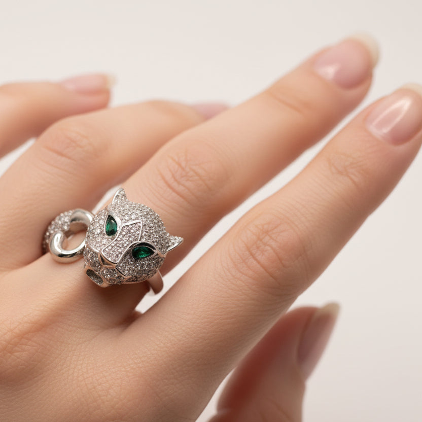 Jewelry set with silver leopard head pendants on a light blue background