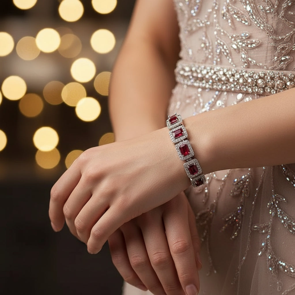 Bracelet with red gemstones and silver accents on a light blue background
