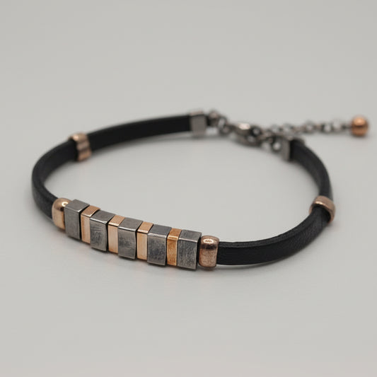 Bracelet with metal beads on a light blue fabric background