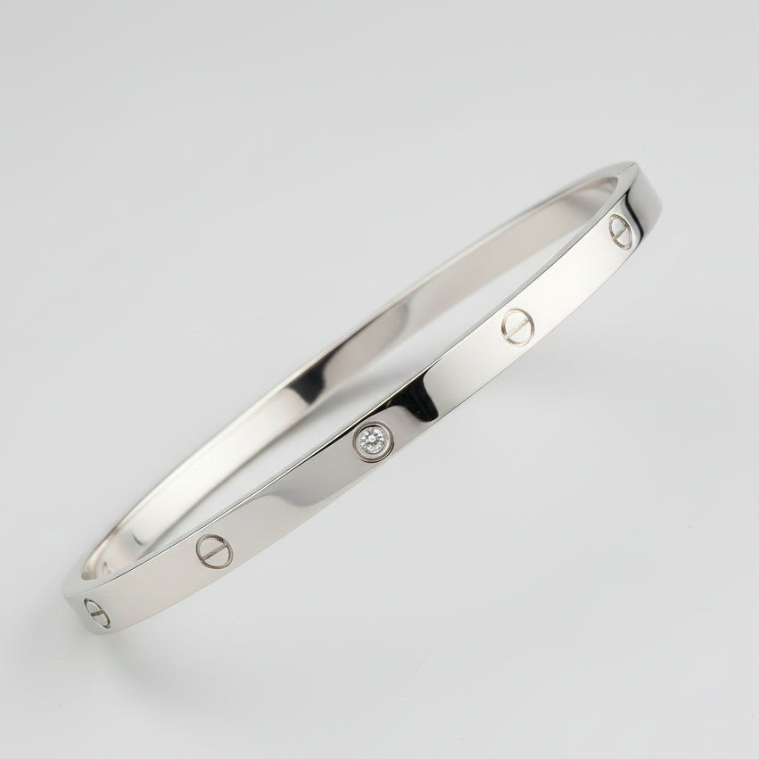 Close-up of a metallic object with engraved details on a textured fabric background