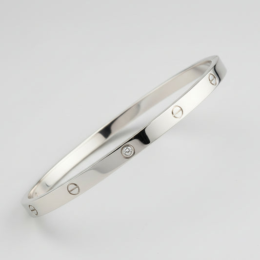 Close-up of a metallic object with engraved details on a textured fabric background