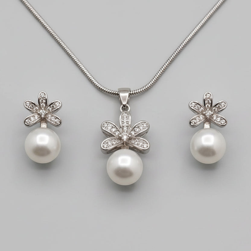 Pearl necklace and earrings on a hand