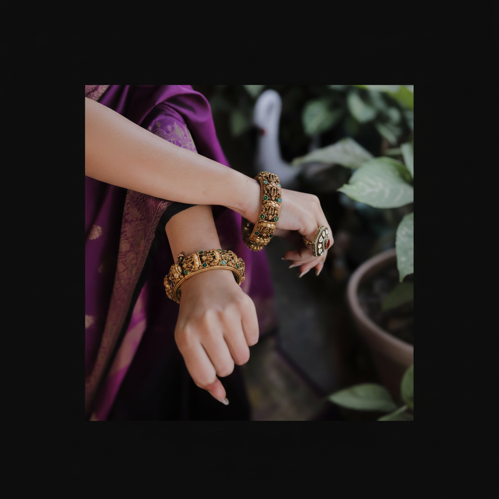 Close-up of hands wearing gold bangles with a blurred natural background