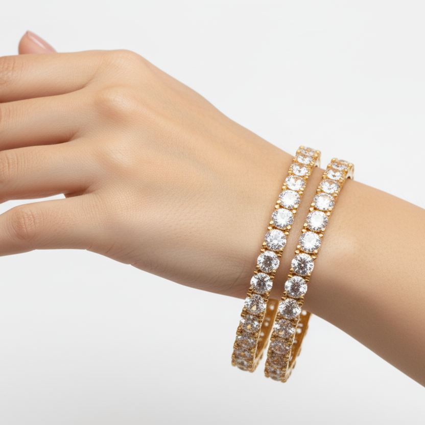 Hand wearing a silver bracelet with clear stones on a light gray background